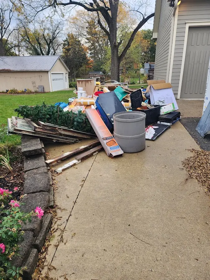 Dumpster being loaded with debris for Roofing Dumpster Rental in Sinton